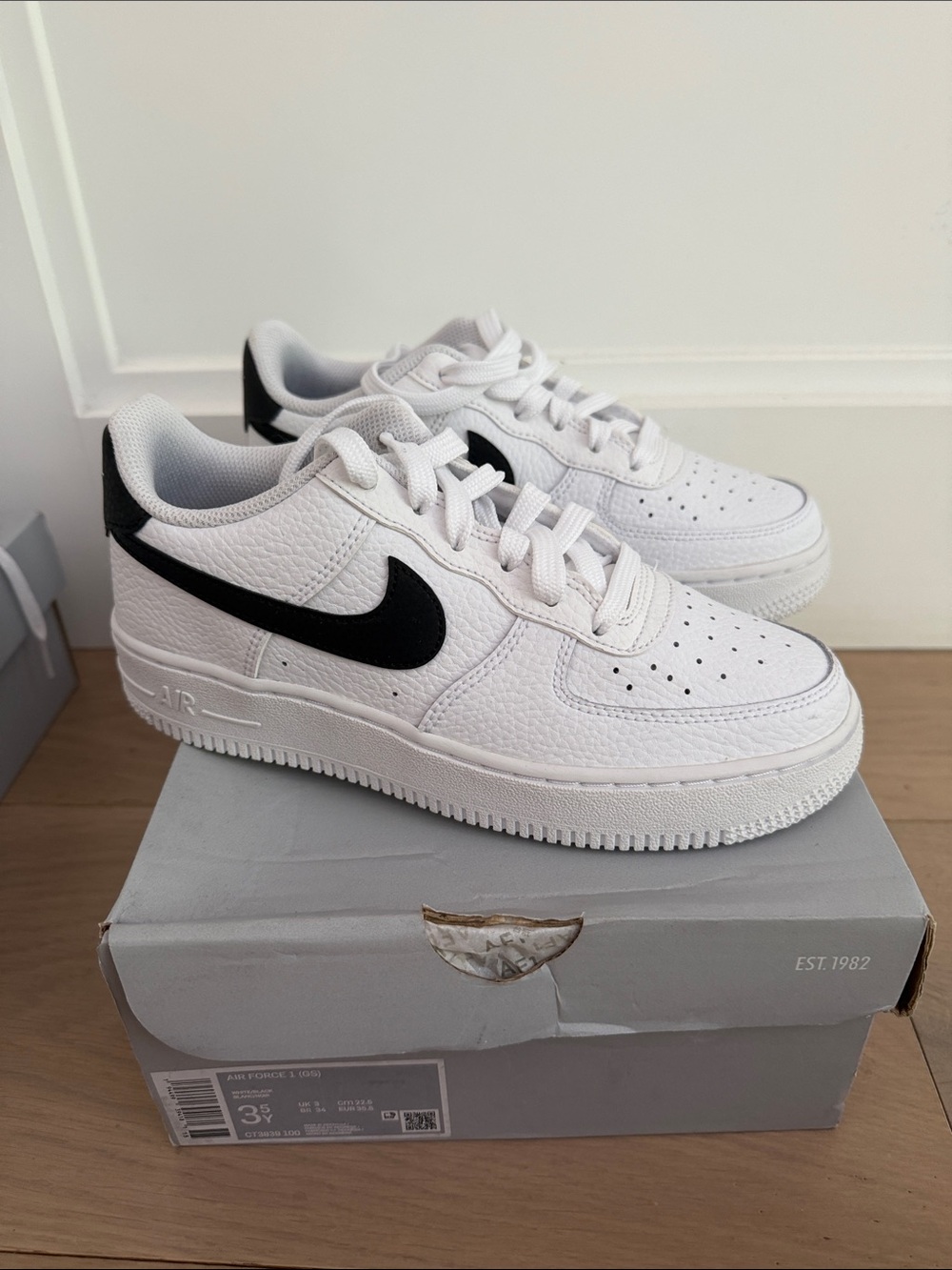 Nike Kids White Sneakers with Black Swoosh